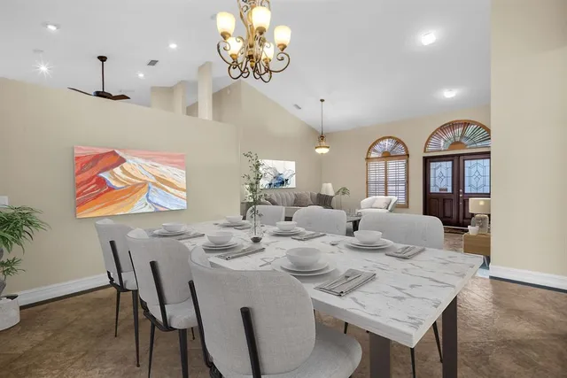 a view of a dining room with furniture a chandelier and wooden floor