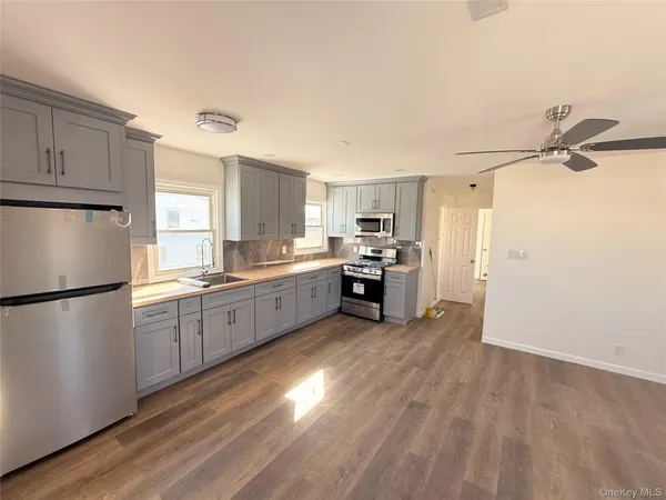 a kitchen with stainless steel appliances a refrigerator sink and cabinets