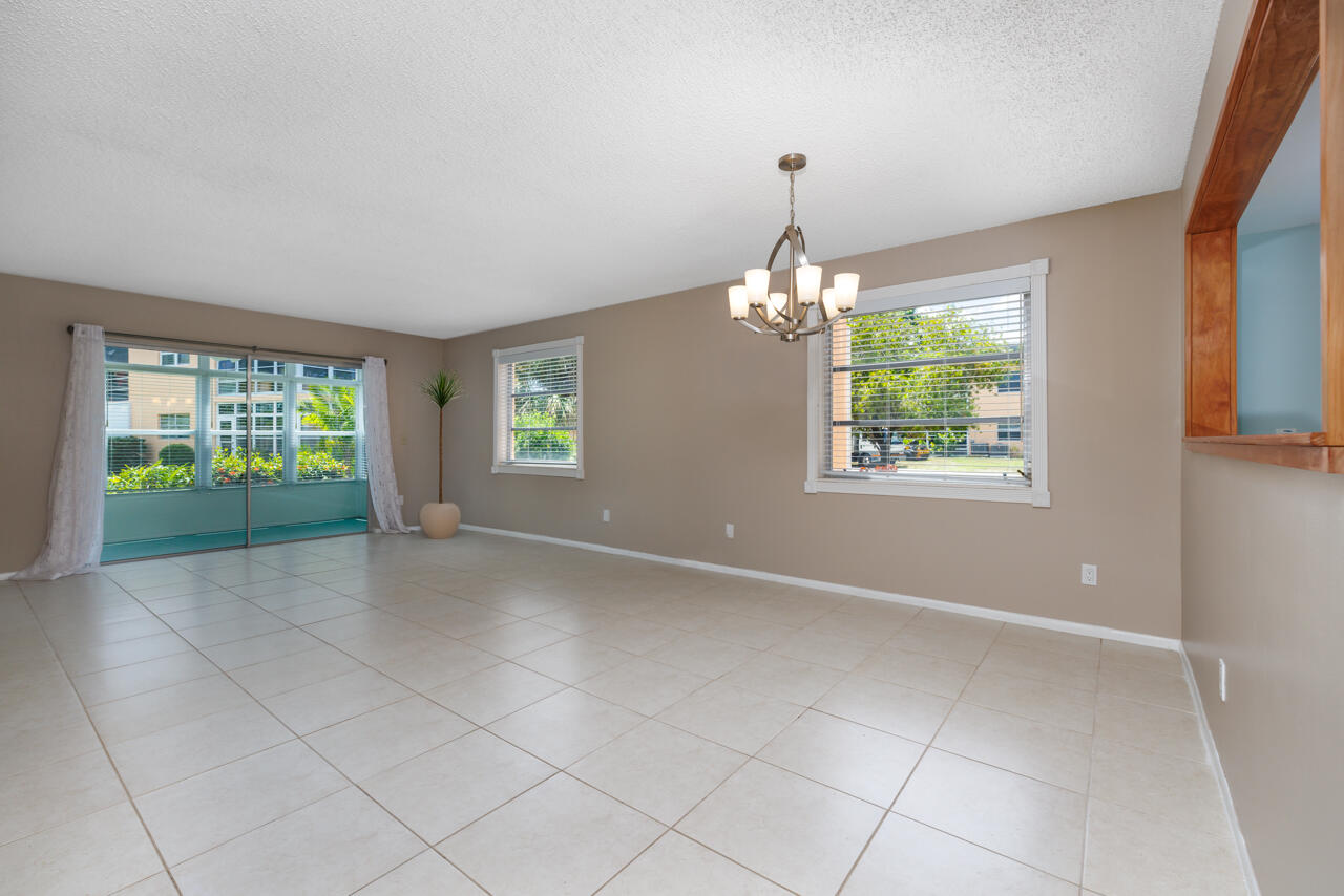 2950 Southeast Ocean Boulevard, Unit 533 Stuart, FL 34996 - Photo 13 of 34 an empty room with windows and chandelier