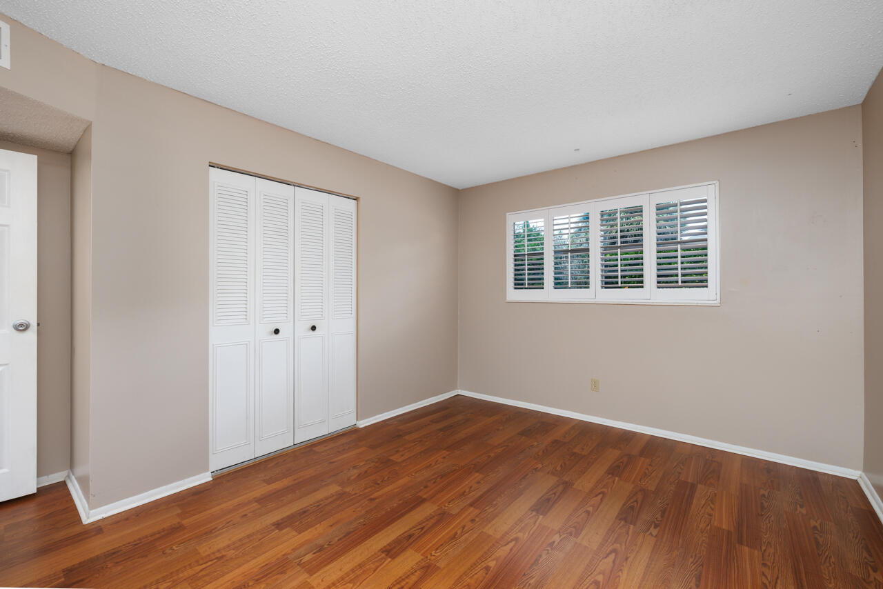 2950 Southeast Ocean Boulevard, Unit 533 Stuart, FL 34996 - Photo 15 of 34 a view of empty room with wooden floor and fan