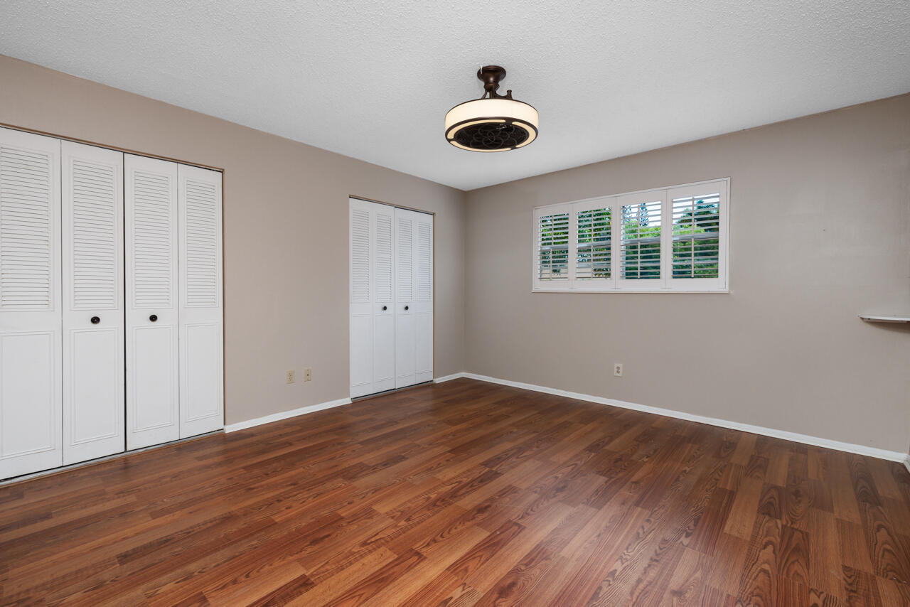 2950 Southeast Ocean Boulevard, Unit 533 Stuart, FL 34996 - Photo 19 of 34 a view of an empty room with wooden floor and a window