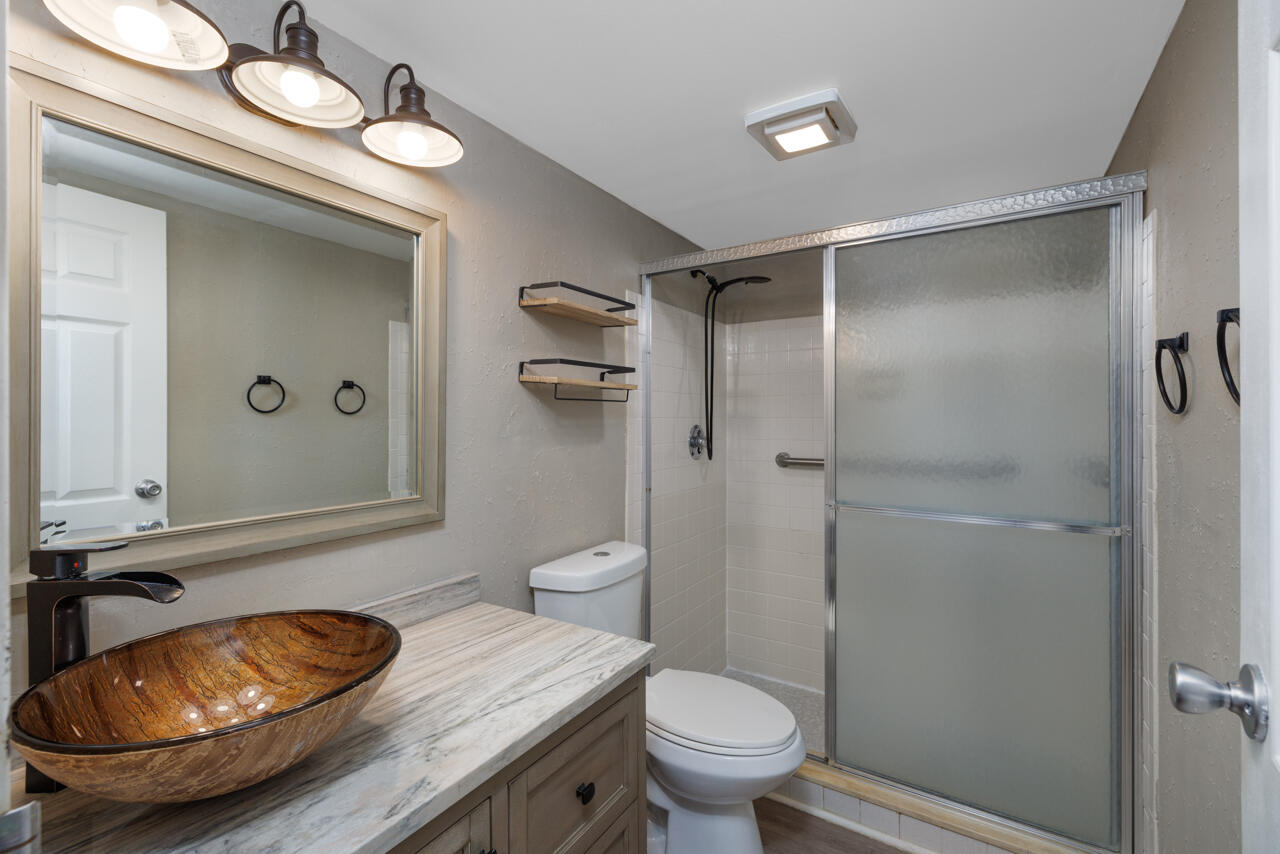 2950 Southeast Ocean Boulevard, Unit 533 Stuart, FL 34996 - Photo 20 of 34 a bathroom with a sink a toilet and shower