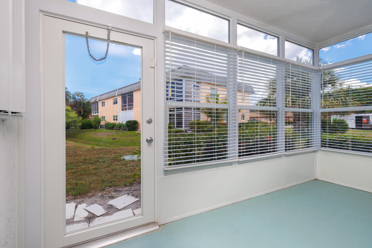2950 Southeast Ocean Boulevard, Unit 533 Stuart, FL 34996 - Photo 21 of 34 a view of a porch with a floor to ceiling window and backyard