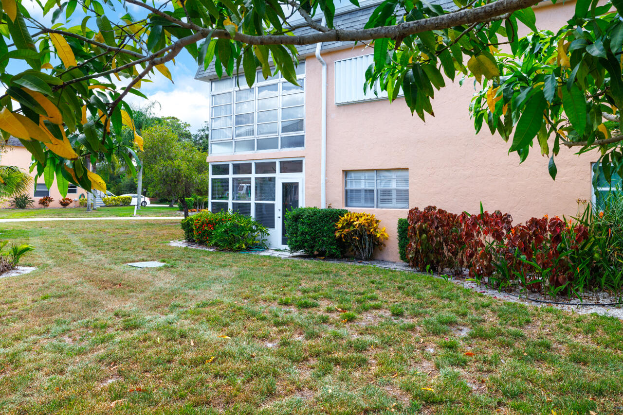 2950 Southeast Ocean Boulevard, Unit 533 Stuart, FL 34996 - Photo 23 of 34 a front view of a house with a yard and trees