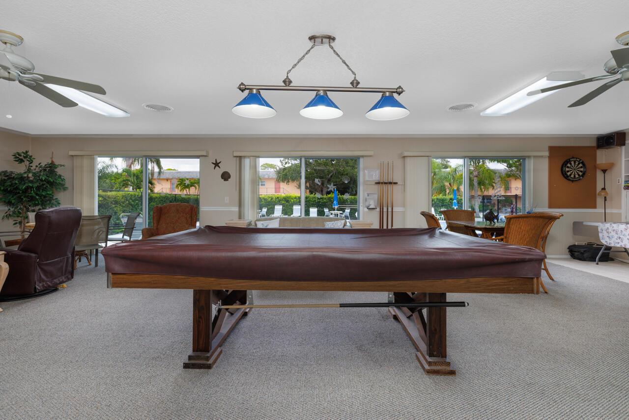 2950 Southeast Ocean Boulevard, Unit 533 Stuart, FL 34996 - Photo 30 of 34 a room with furniture pool table and windows
