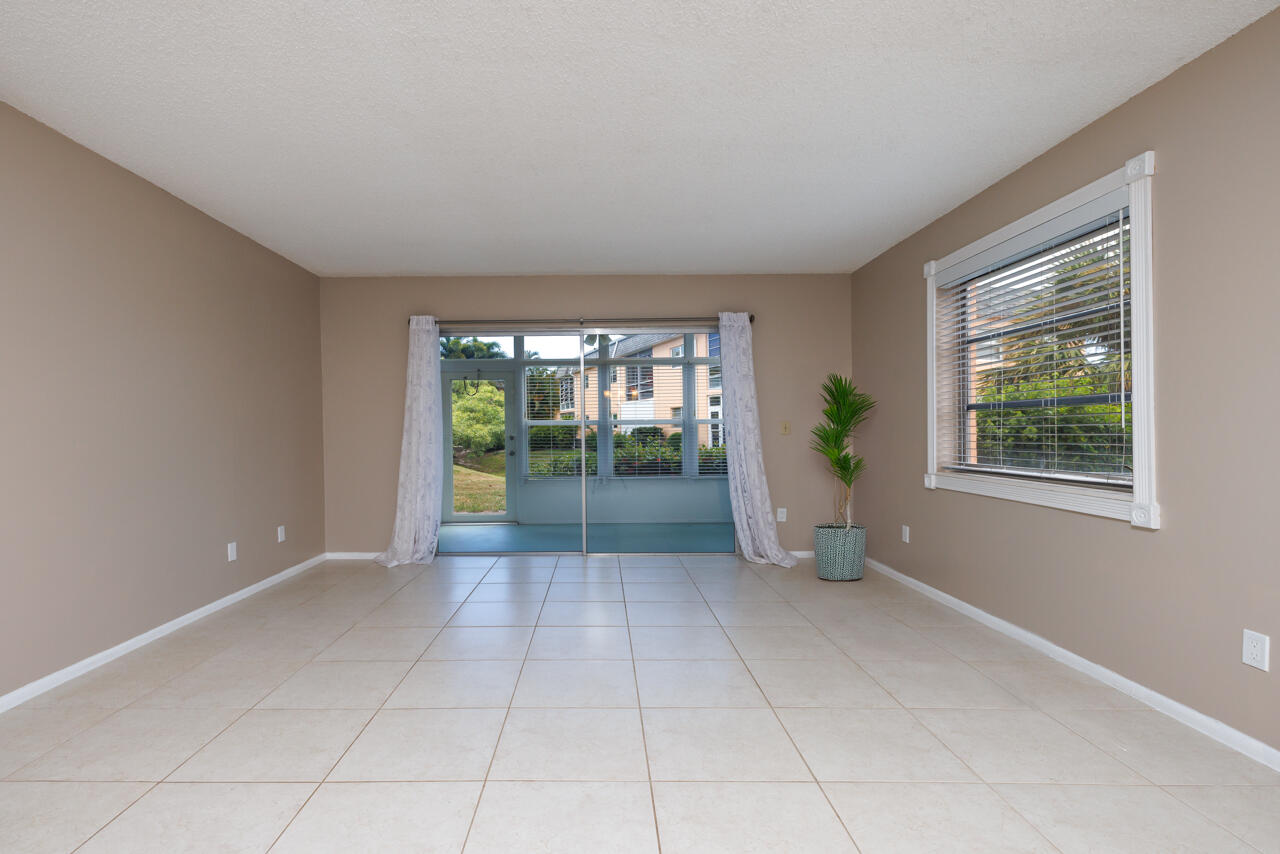 2950 Southeast Ocean Boulevard, Unit 533 Stuart, FL 34996 - Photo 5 of 34 a view of an empty room with glass door and balcony
