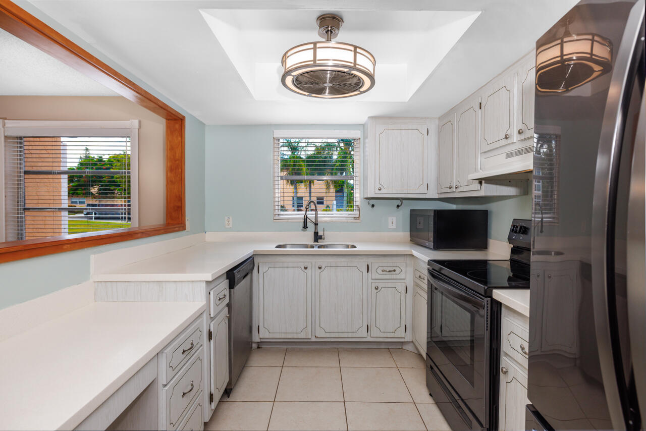 2950 Southeast Ocean Boulevard, Unit 533 Stuart, FL 34996 - Photo 10 of 34 a kitchen with a sink dishwasher a stove and a refrigerator