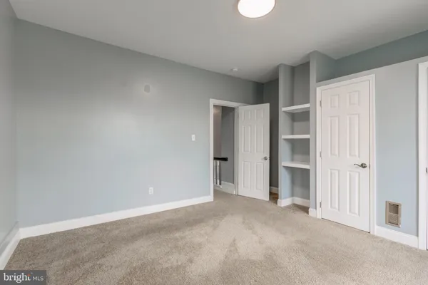 a view of an empty room and closet area