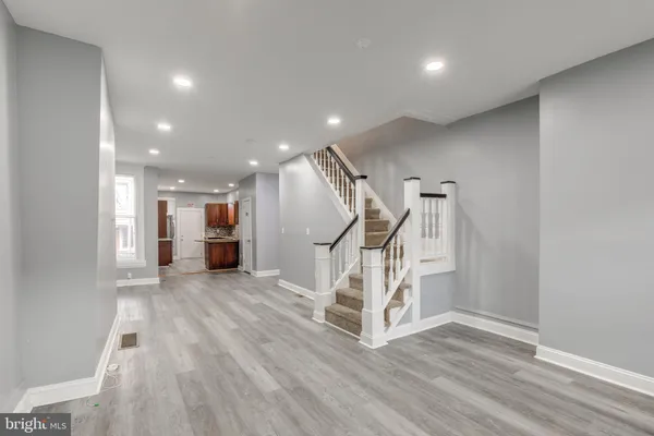 a view of entryway and hall with wooden floor