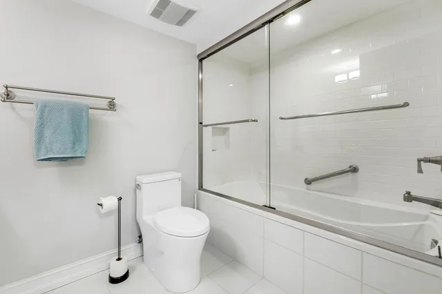 a bathroom with a toilet and a shower
