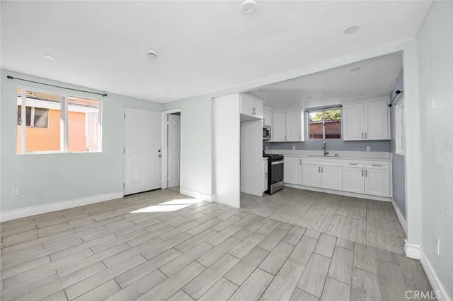 a view of a kitchen with a sink cabinets and a window