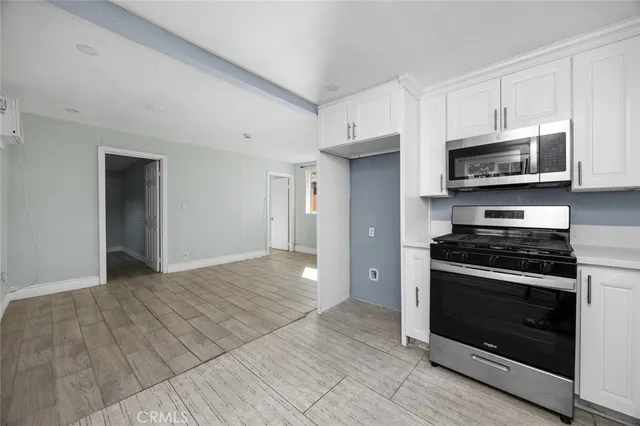 a kitchen with stainless steel appliances granite countertop a stove and a refrigerator