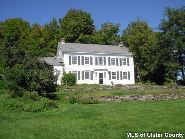 483 Travis Hill Road Rensselaerville, NY 12469 - Photo 1 of 1 a front view of a house with a garden