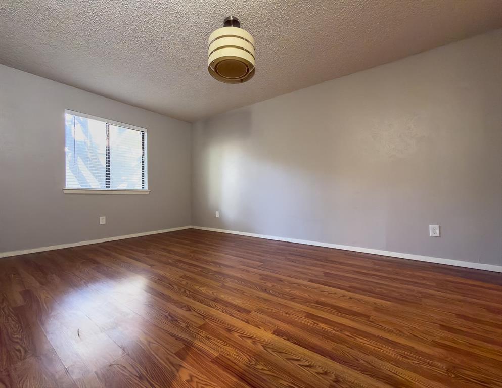 6646 East Lovers Lane, Unit 602 Dallas, TX 75214 - Photo 13 of 19 an empty room with wooden floor and windows