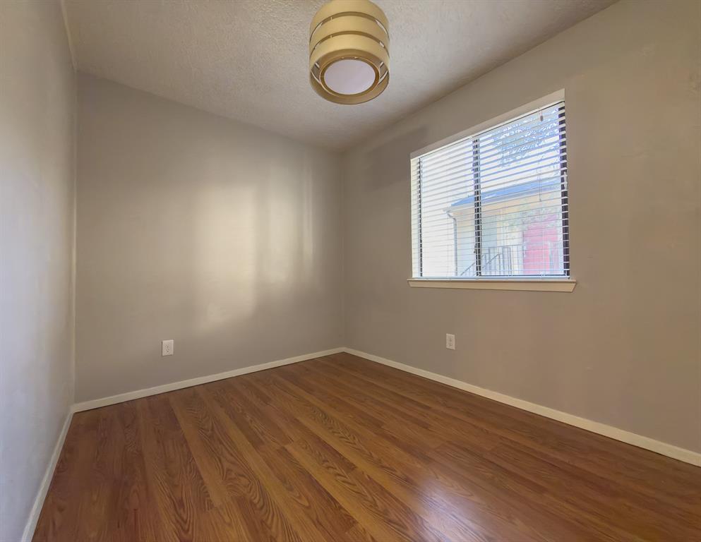 6646 East Lovers Lane, Unit 602 Dallas, TX 75214 - Photo 16 of 19 an empty room with wooden floor and windows