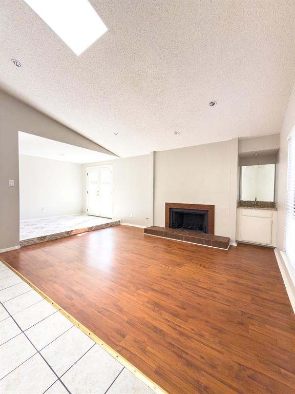 6646 East Lovers Lane, Unit 602 Dallas, TX 75214 - Photo 4 of 19 an empty room with wooden floor and fireplace