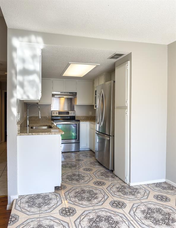 6646 East Lovers Lane, Unit 602 Dallas, TX 75214 - Photo 8 of 19 a kitchen with a refrigerator and a sink