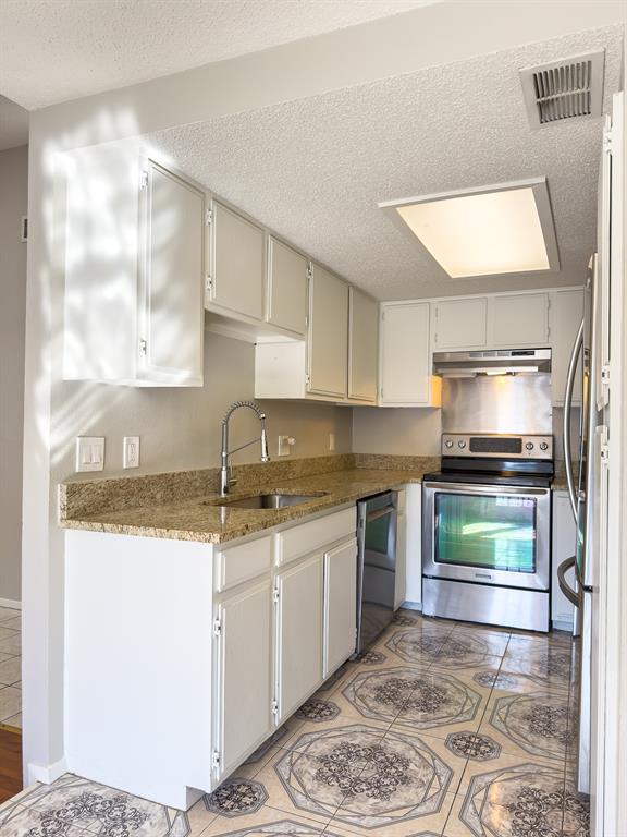 6646 East Lovers Lane, Unit 602 Dallas, TX 75214 - Photo 9 of 19 a kitchen with stainless steel appliances granite countertop a sink stove and cabinets