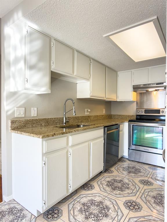6646 East Lovers Lane, Unit 602 Dallas, TX 75214 - Photo 10 of 19 a kitchen with granite countertop a sink and a stove