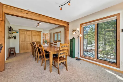 a living room with furniture a window and a chandelier