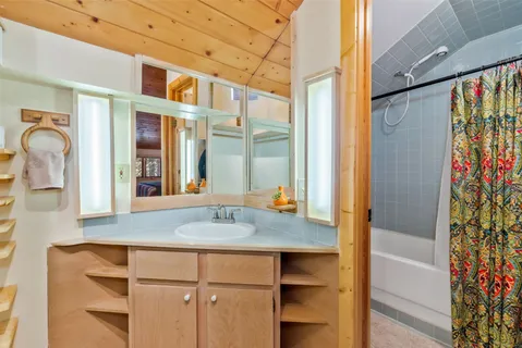 a view of an empty room with window and cabinet