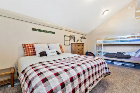 a bedroom with a bed and a lamp