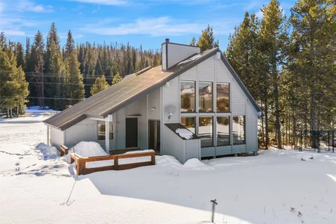 a view of a house with a snow in the background