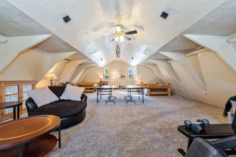 a view of a livingroom with furniture and a ceiling fan