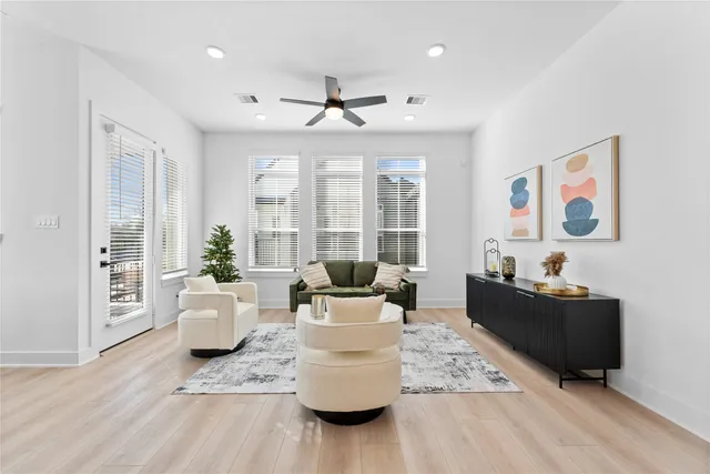 a living room with furniture and wooden floor