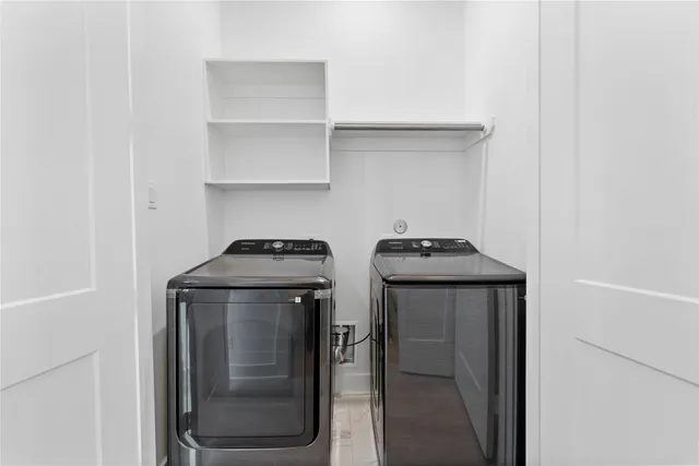 a utility room with two washing machine