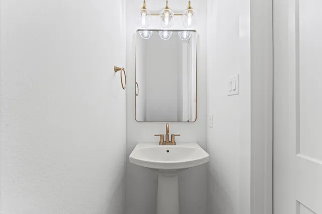 a bathroom with a sink a mirror and shower