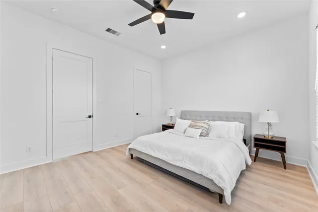 a bedroom with a bed and a ceiling fan