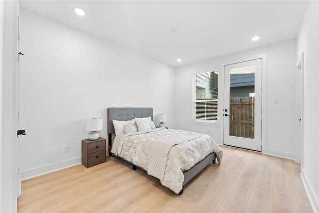 a bedroom with a bed and a large window