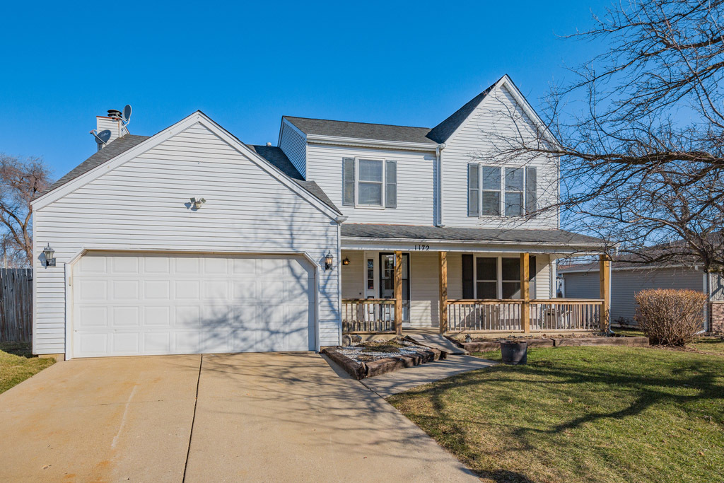 1172 Sunbury Road South Elgin, IL 60177 - Photo 1 of 1 a view of a white house with large windows next to a yard