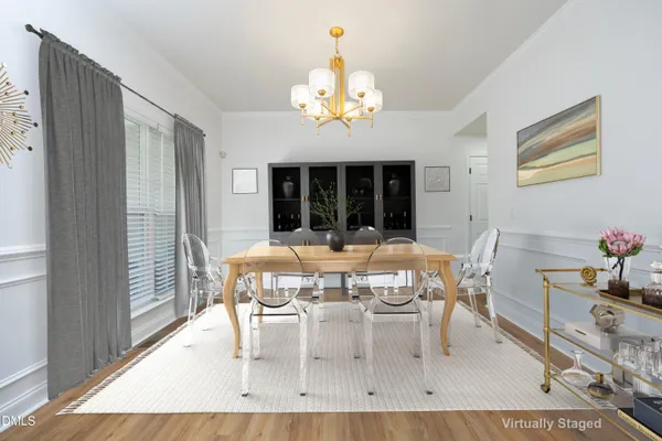 a view of a dining room with furniture and chandelier