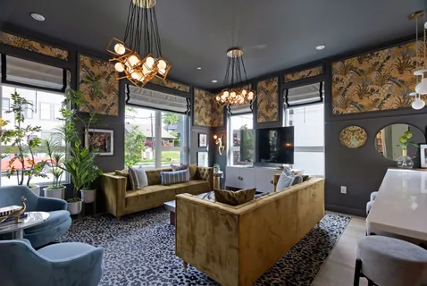 a living room with furniture flat screen tv and a large window