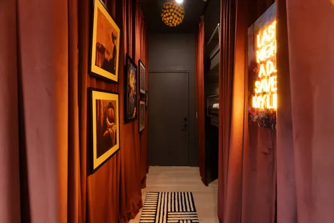 a view of a hallway with windows and chandelier