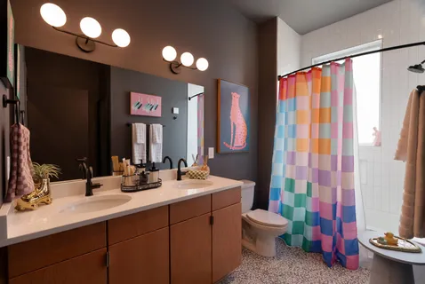 a bathroom with a sink vanity mirror and toilet