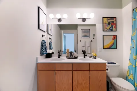 a bedroom with two beds and a potted plant