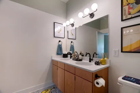 a bedroom with furniture and a rug