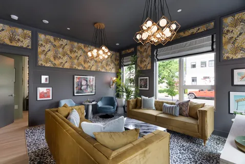 a living room with furniture a chandelier and a large window