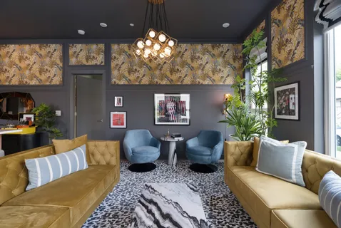 a living room with furniture and a chandelier