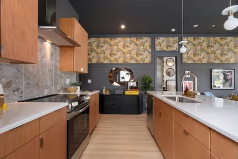 a kitchen with stainless steel appliances a sink stove and cabinets