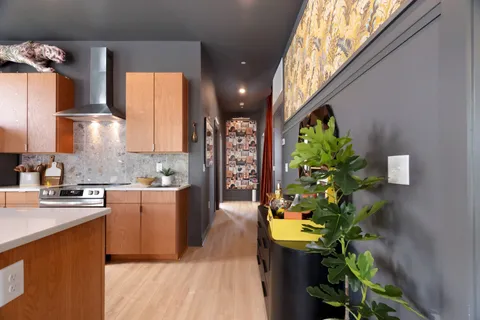 a kitchen with stainless steel appliances a white cabinets a sink and a counter