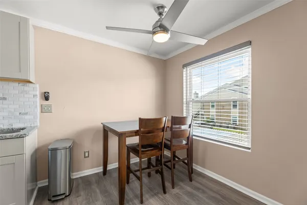 a view of a dining room with furniture and a window