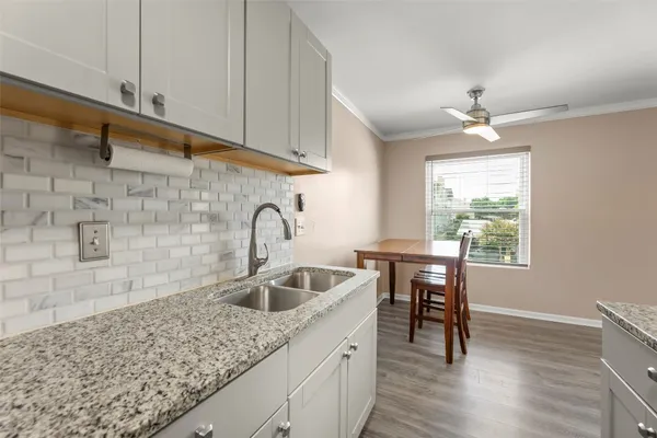 a kitchen with sink cabinets and window