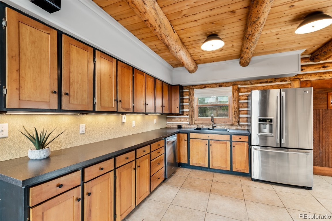 1527 Natches Road Steamboat Springs, CO 80487 - Photo 13 of 50 a kitchen with stainless steel appliances granite countertop a refrigerator a sink and dishwasher