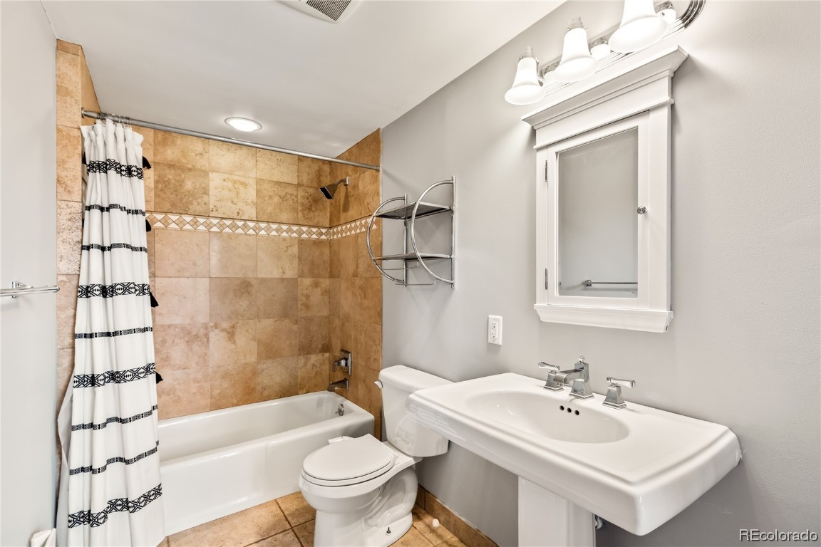 1527 Natches Road Steamboat Springs, CO 80487 - Photo 16 of 50 a bathroom with a sink toilet tub and shower