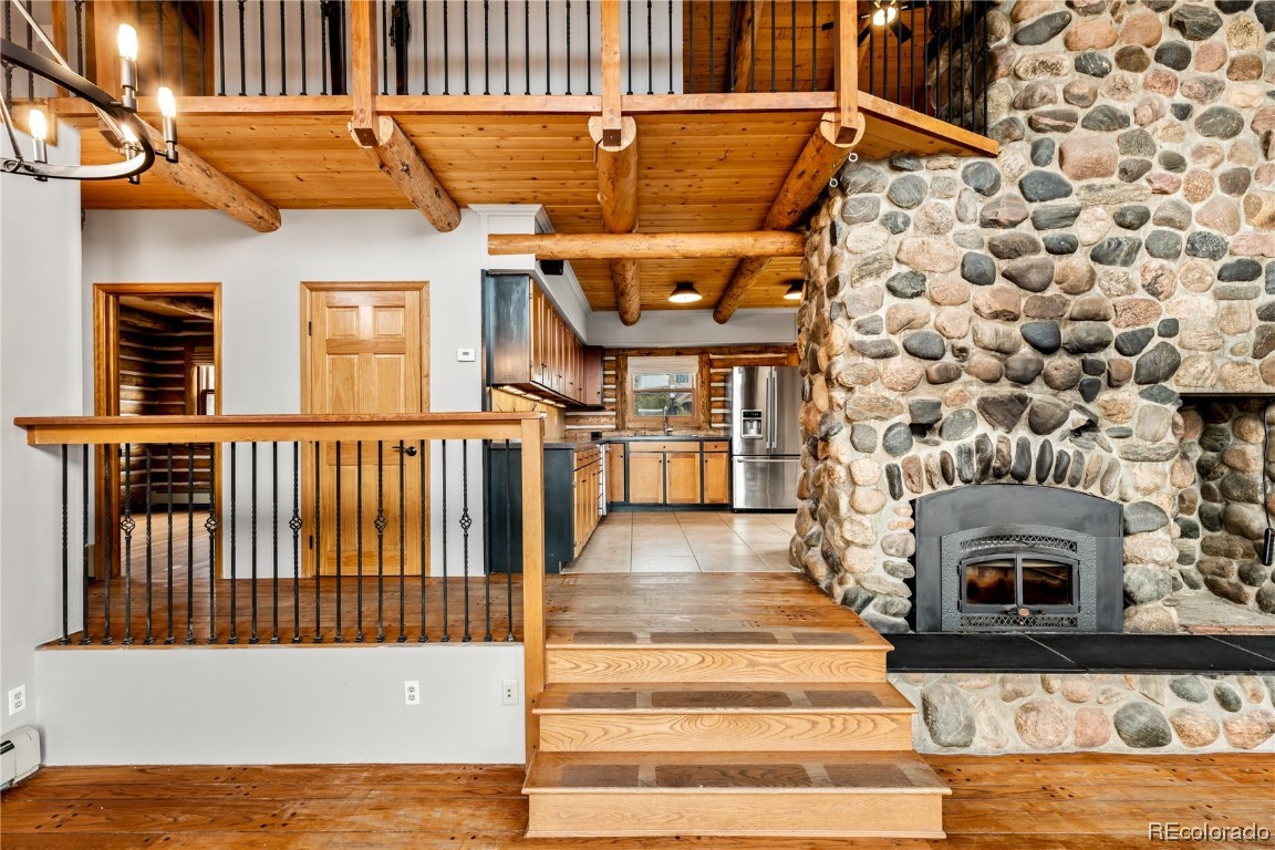 1527 Natches Road Steamboat Springs, CO 80487 - Photo 2 of 50 a view of a fireplace with wooden floor and a fireplace