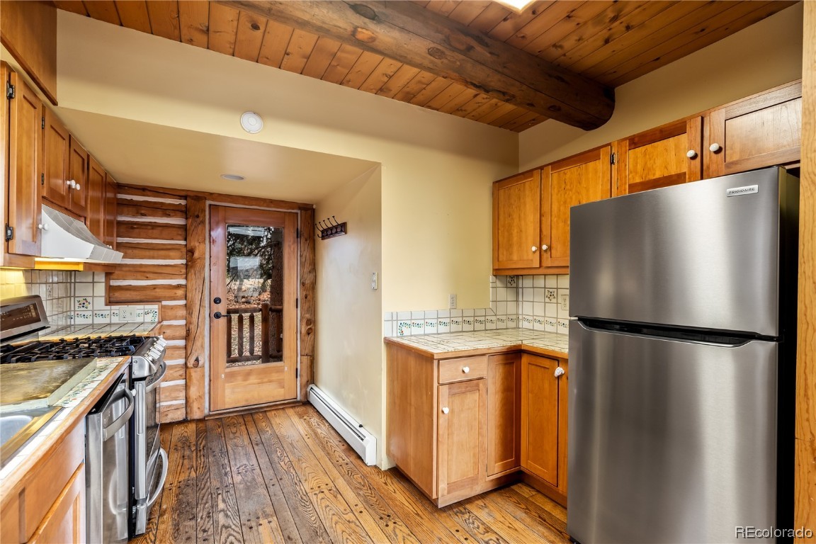 1527 Natches Road Steamboat Springs, CO 80487 - Photo 36 of 50 a kitchen with stainless steel appliances a refrigerator and a stove top oven